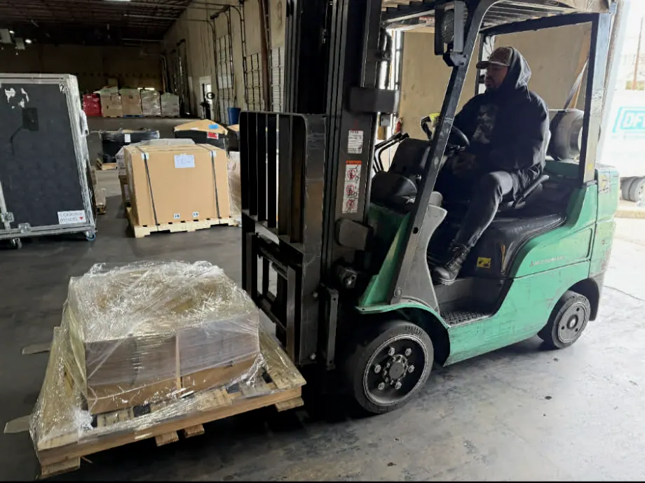 Forklift loading protected equipment for scheduled delivery