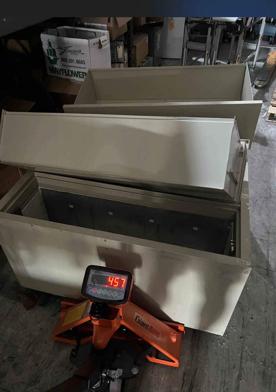 Wrapped commercial furniture staged on a pallet jack for protection